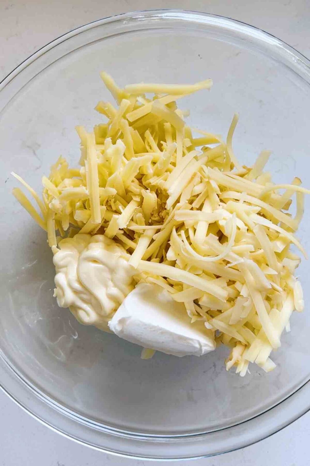 shredded cheese in a glass bowl. 