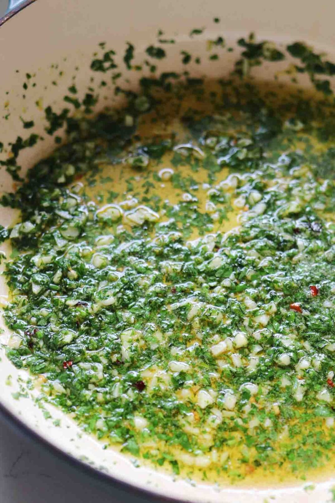 bright parsley, garlic, and olive oil sauce in a sauce pan.