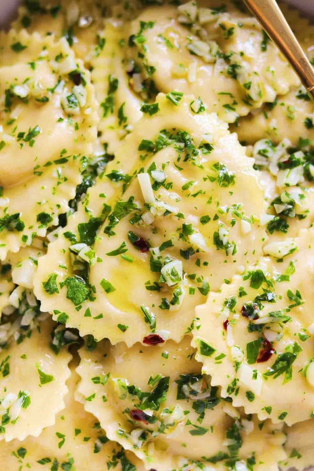an up close view of Trader Joe's Roasted Cauliflower Ravioli with a parsley garlic olive oil sauce.