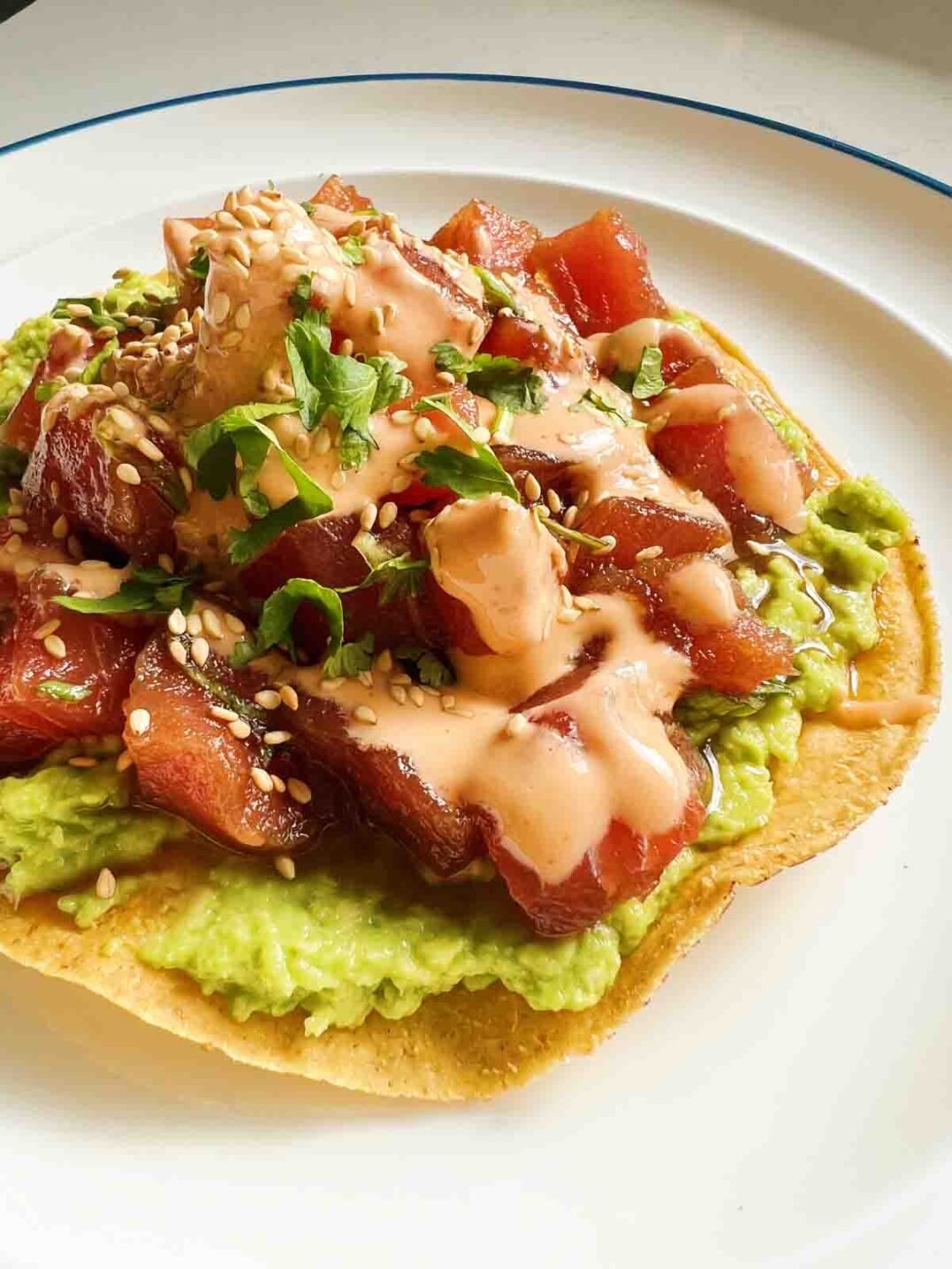 tuna tostada on a white plate.