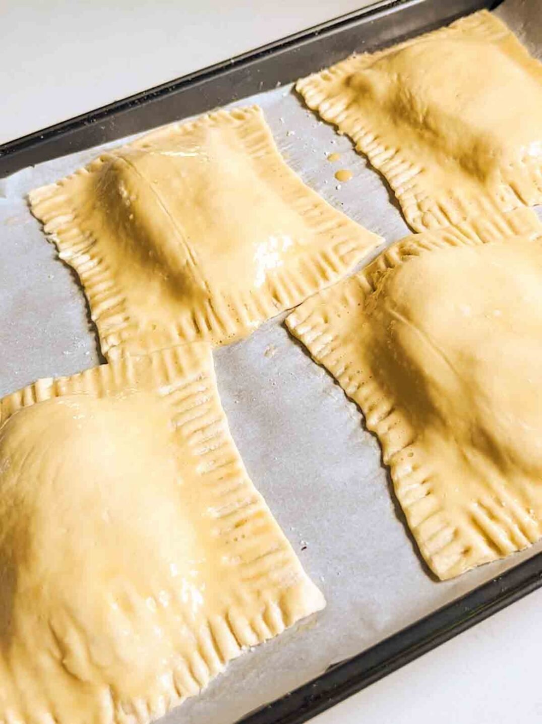 puff pastry rectangles on a parchment lined baking sheet.