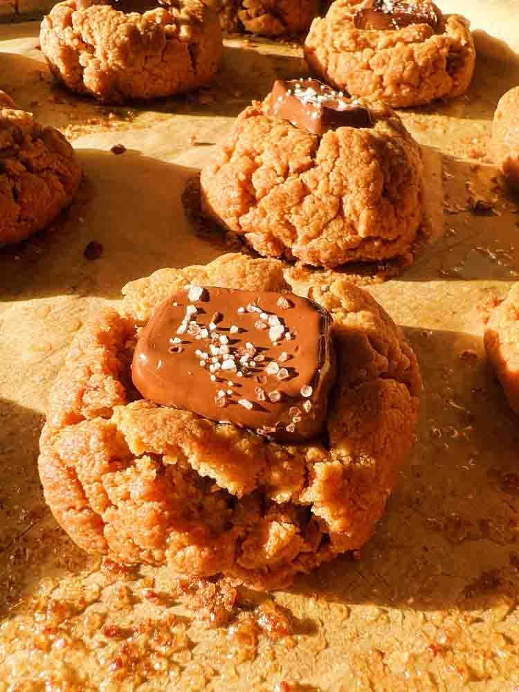 a salted caramel 4 ingredient peanut butter cookie on a baking sheet.