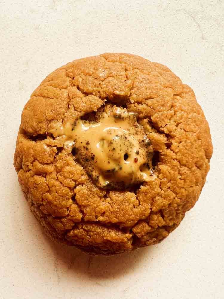 a single 4 ingredient peanut butter cookie with a P.B. Bite melted in the middle.