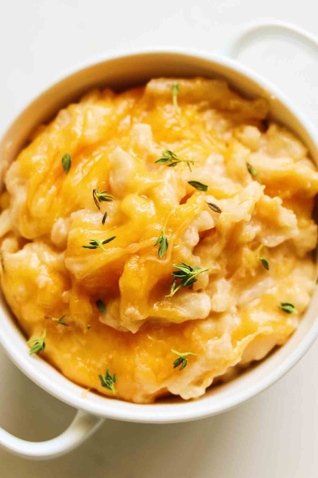 Cheesy Crockpot Potatoes in a white bowl.