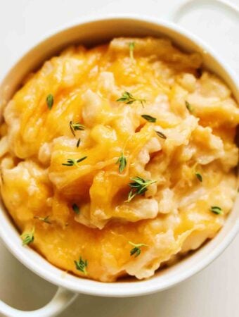 Cheesy Crockpot Potatoes in a white bowl.