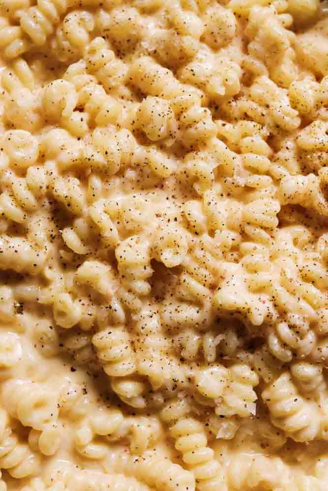 a close up view of the noodles in a creamy gouda mac and cheese.