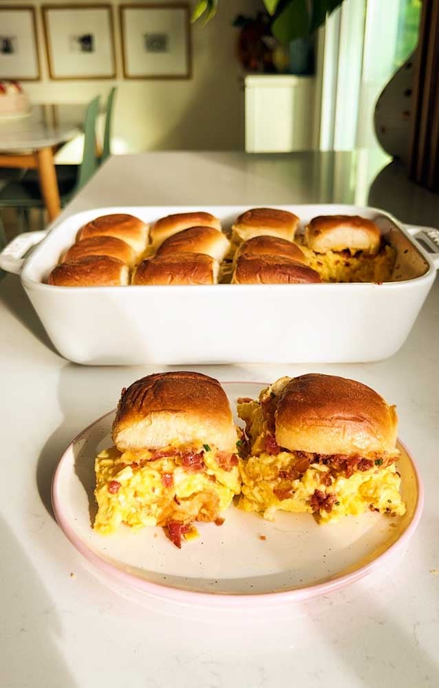 a white plate topped with two hawaiian roll breakfast sliders. 