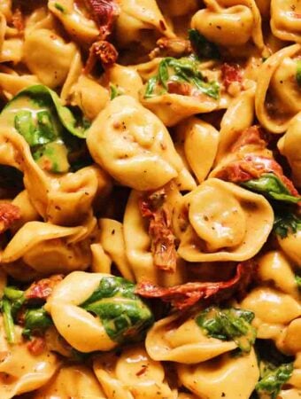 a close up view of a bowl of marry me tortellini.