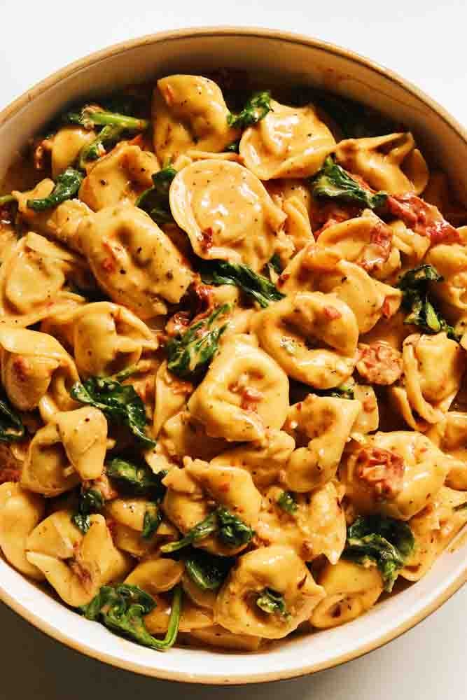 a white bowl filled with marry me tortellini. 