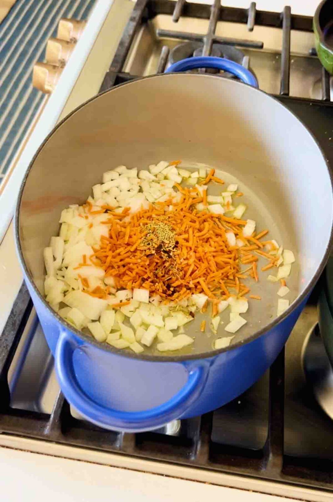 sauteed carrots, onions and garlic in a big blue pot. 