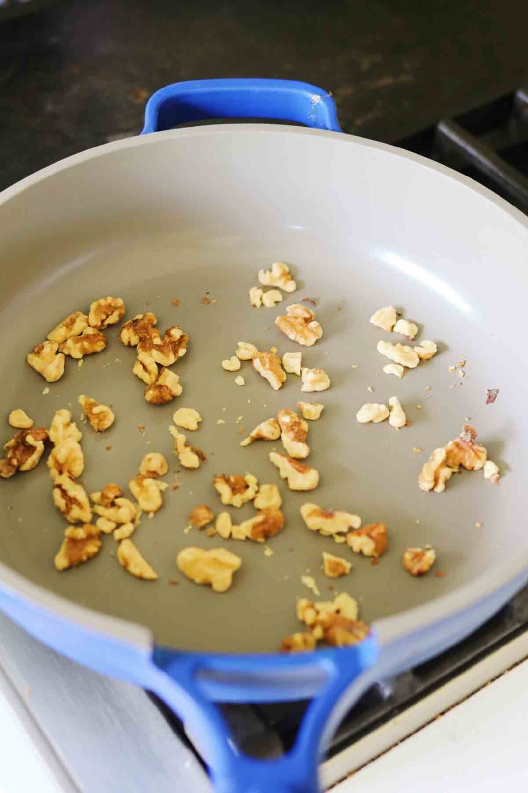 walnuts toasting in a pan.