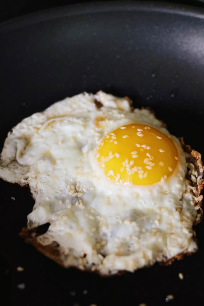 a crispy fried egg with sesame seeds and sesame oil 