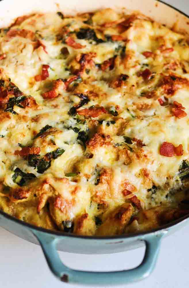bacon and cheese strata in a blue braising dish.