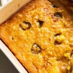 jiffy spoon bread in a white great jones baking dish.