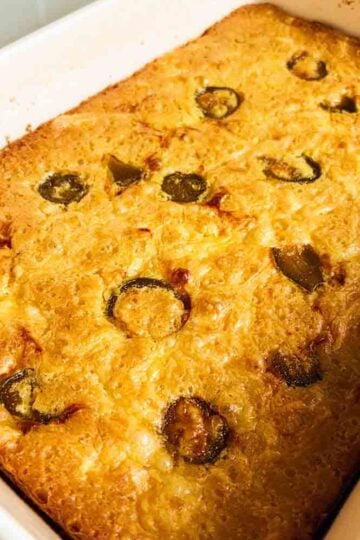a birds eye view of a baking dish filled with spoon bread casserole.
