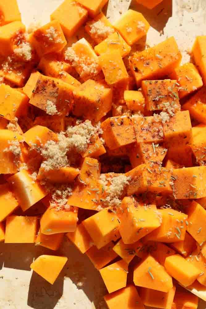 raw butternut squash topped with brown sugar, rosemary, salt and cinnamon.