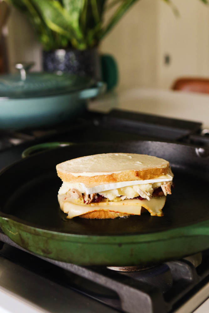 a turkey cranberry sandwich in a big great jones king sear pan. 