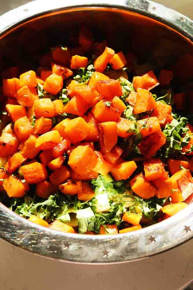 roasted butternut squash, kale and pasta in a big bowl.