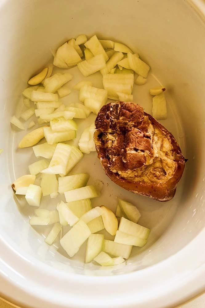 a smoked ham hock and dived sweet onion in a crockpot. 