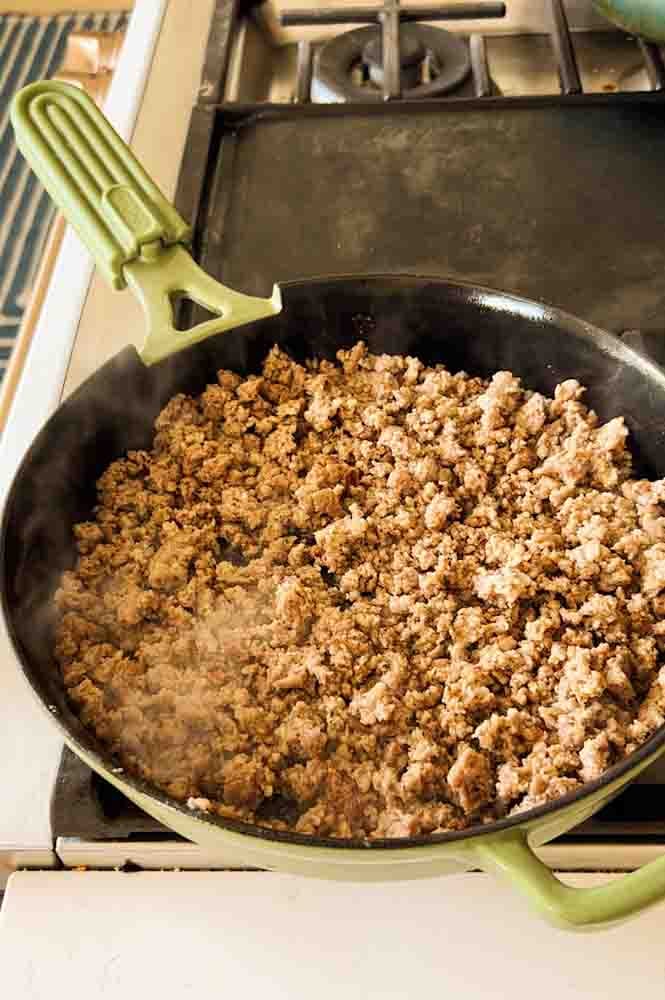 cooked sausage crumbles in a cast iron skillet. 