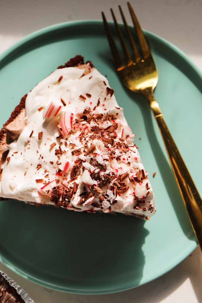 an overhead view of a piece of frozen hot chocolate pie on a blue plate. 