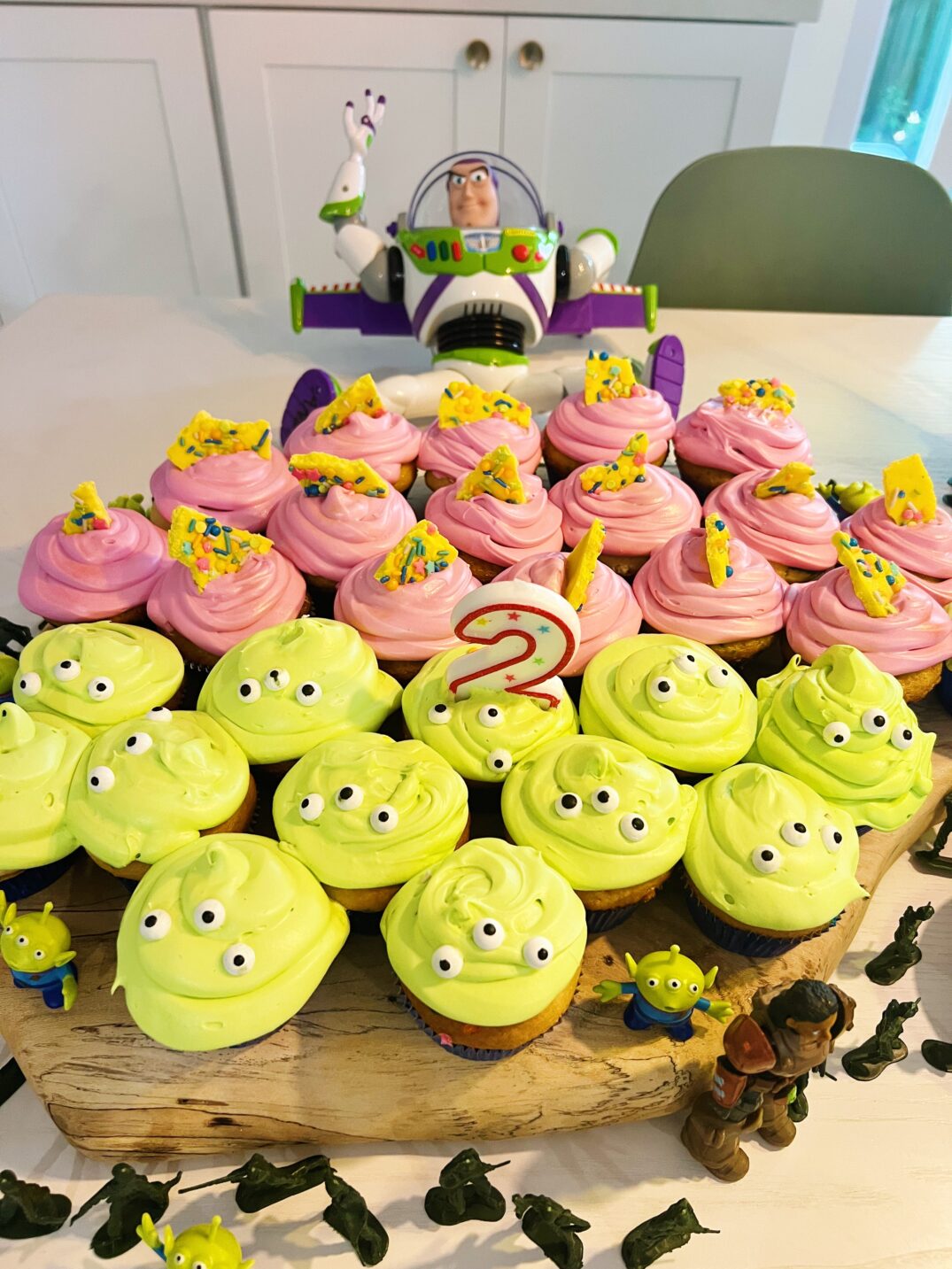 homemade toy story alien cupcakes on a cutting board. 