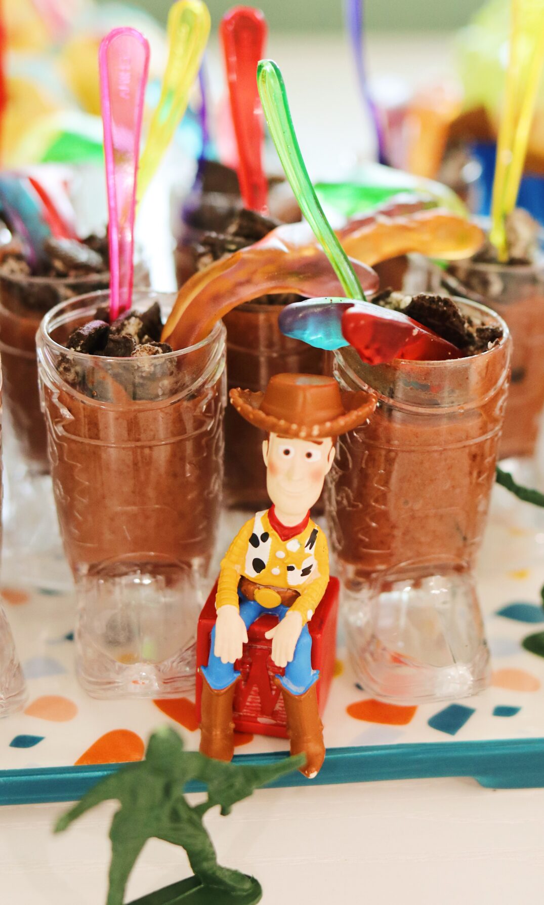 a platter full of snake in my boot chocolate pudding cup with woody sitting in front of it.