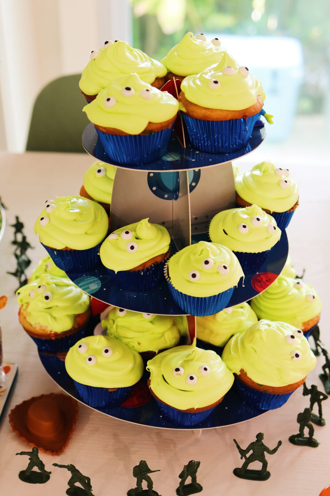 toy story alien cupcakes on a spaceship cupcake holder. 