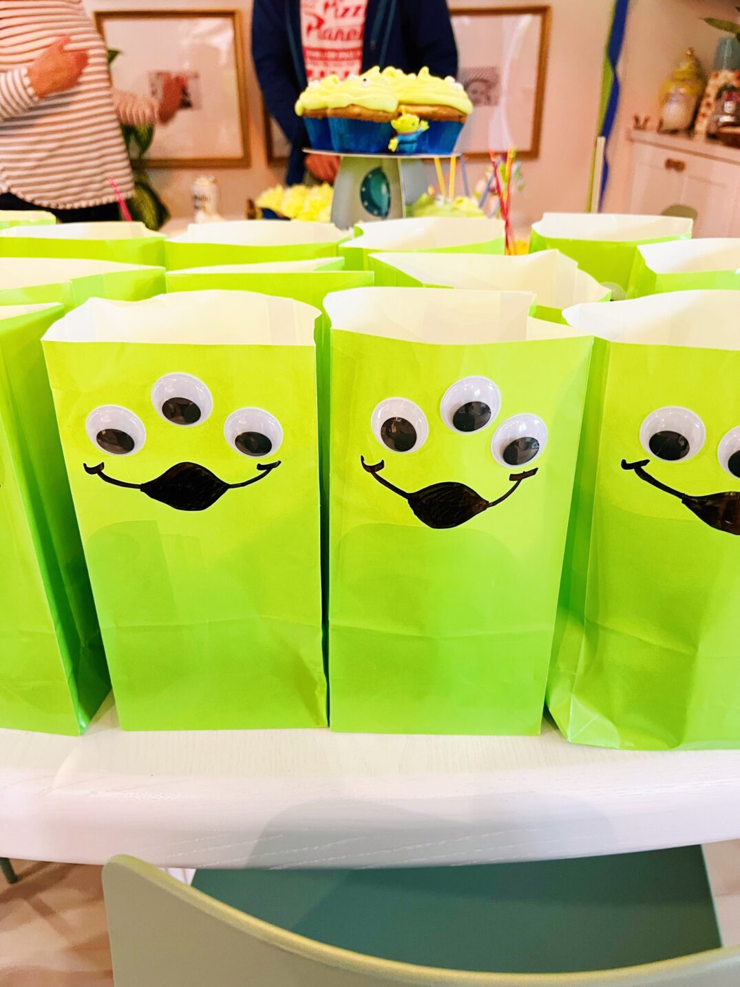 toy story birthday party goodie bags sitting on a white table. 
