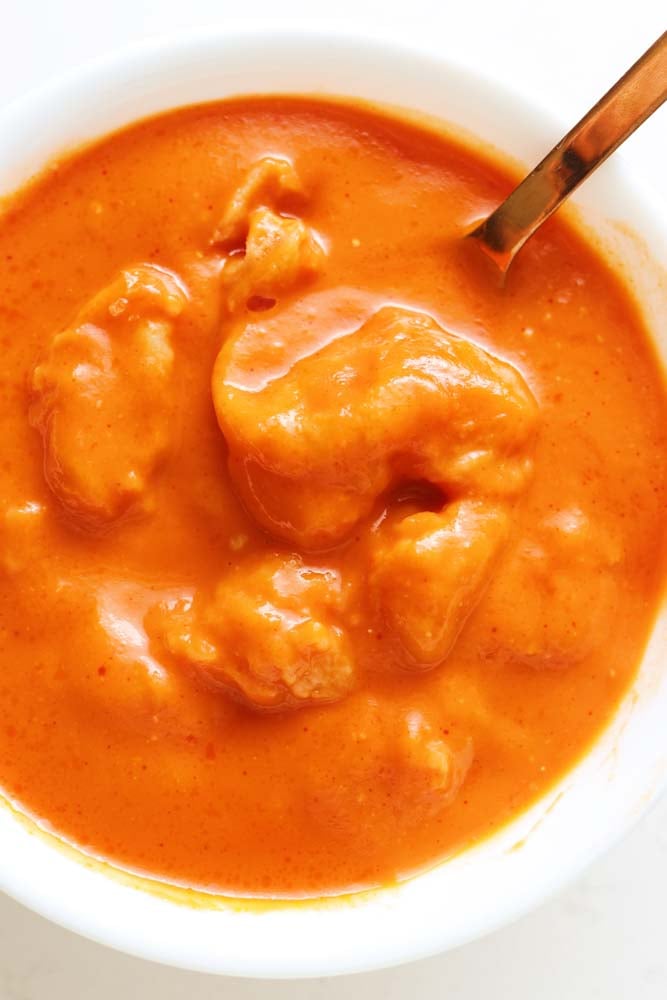 an overhead view of a bowl of cheese dumpling tomato soup.