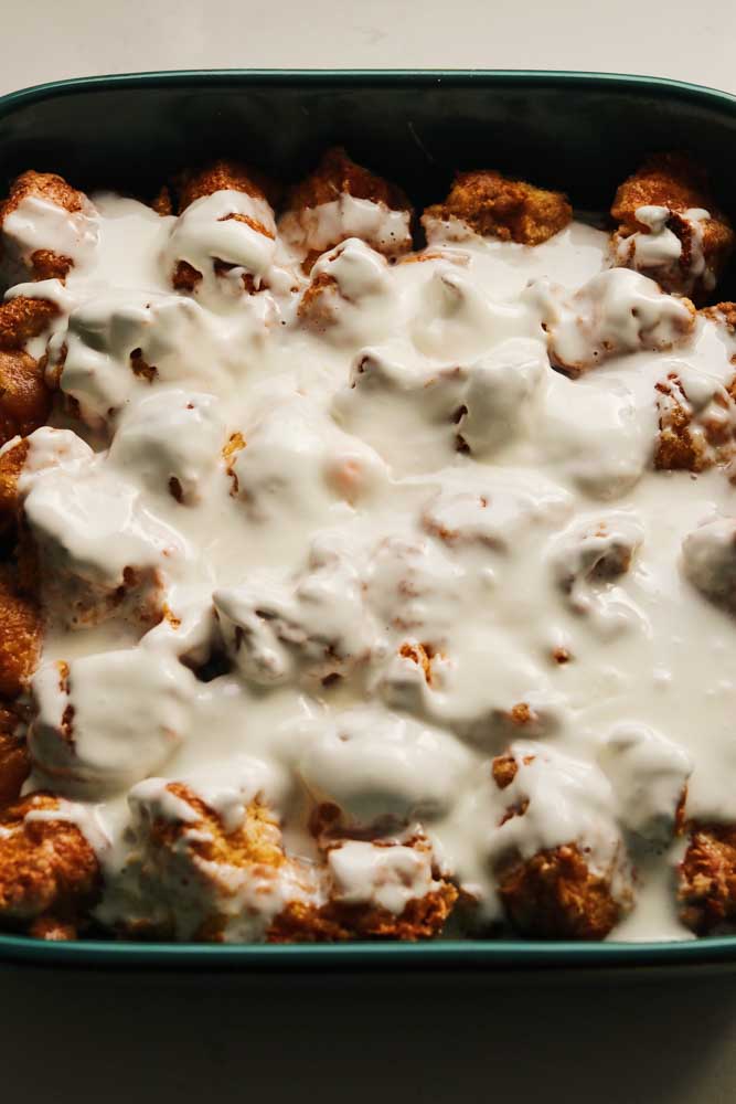 king cake monkey bread with a drizzle of cream cheese frosting. 