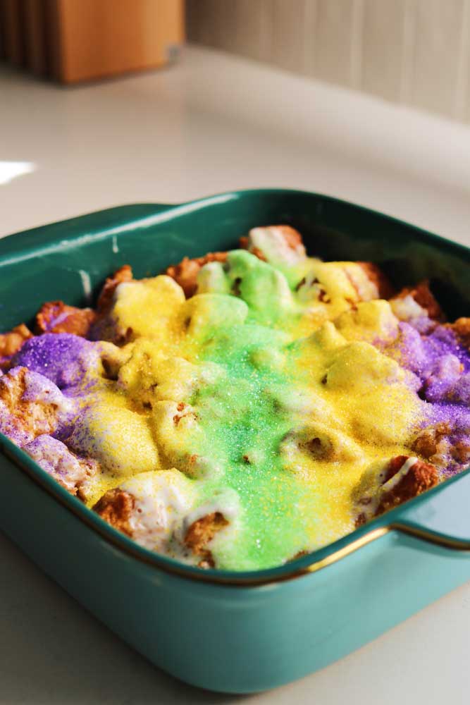an ¾ angled view of a blue baking dish filled with kings hawaiian king cake. 