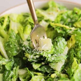 a bowl of caesar salad without anchovies.