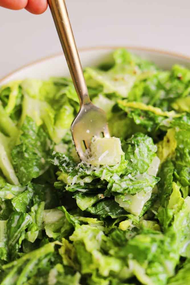 a bowl of caesar salad without anchovies. 