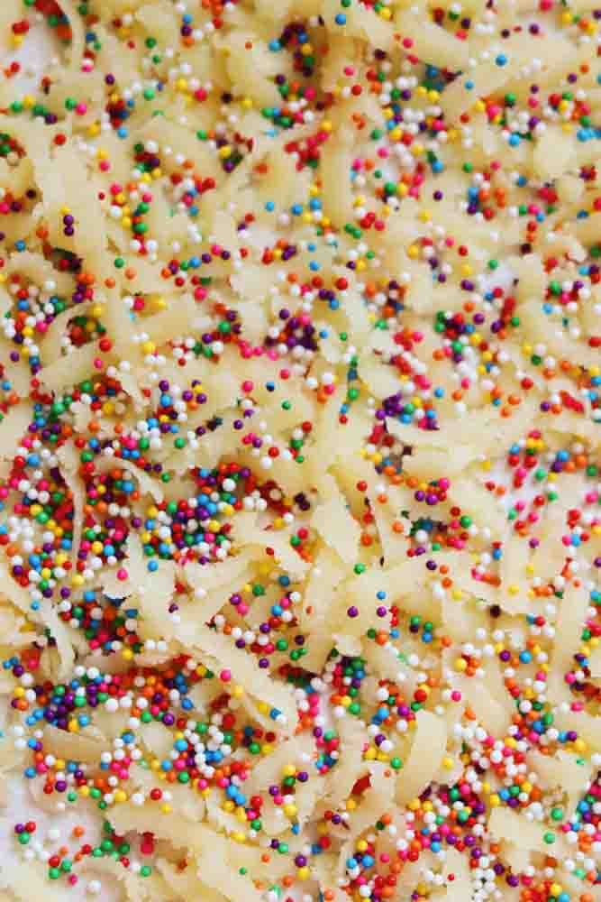 grated almond paste and rainbow sprinkles on a sheet of puff pastry. 