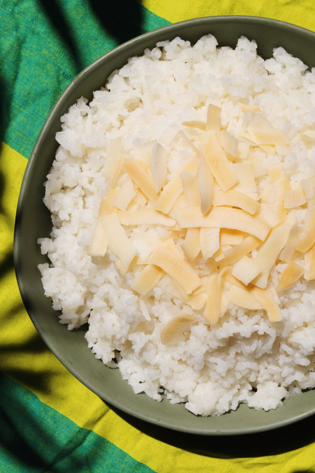 an overhead view of a bowl of coconut rice cooked in the rice cooker. 
