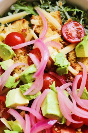 colorful cornbread salad recipe in a white bowl.