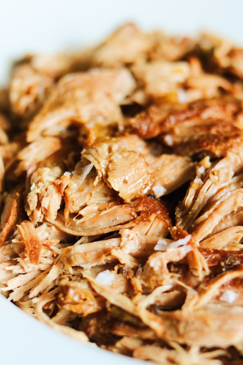 an up close picture of a bowl of dr pepper pulled pork.