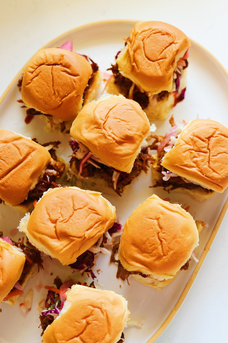 an overhead view of a platter of pulled pork sliders.