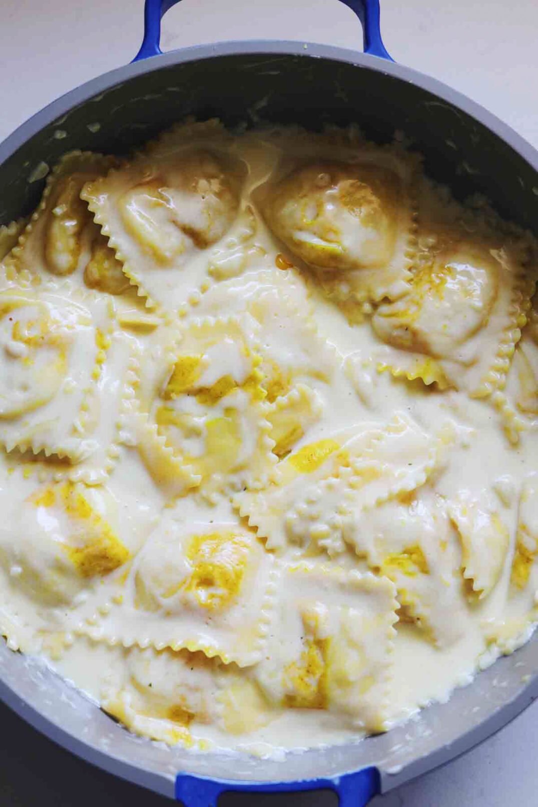 sweet corn ravioli being tossed in a creamy white sauce. 