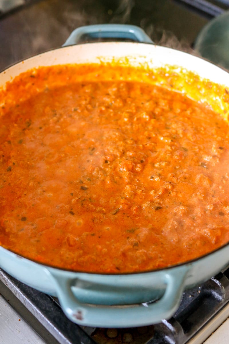 tomato sauce with melted boursin cheese in a big blue pot. 