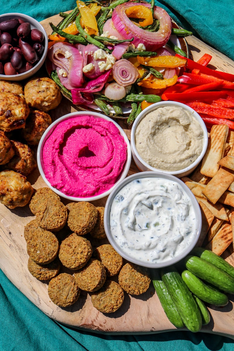 colorful dips, spreads, and crunchy veggies and appetizers on a Greek Appetizer Platter.
