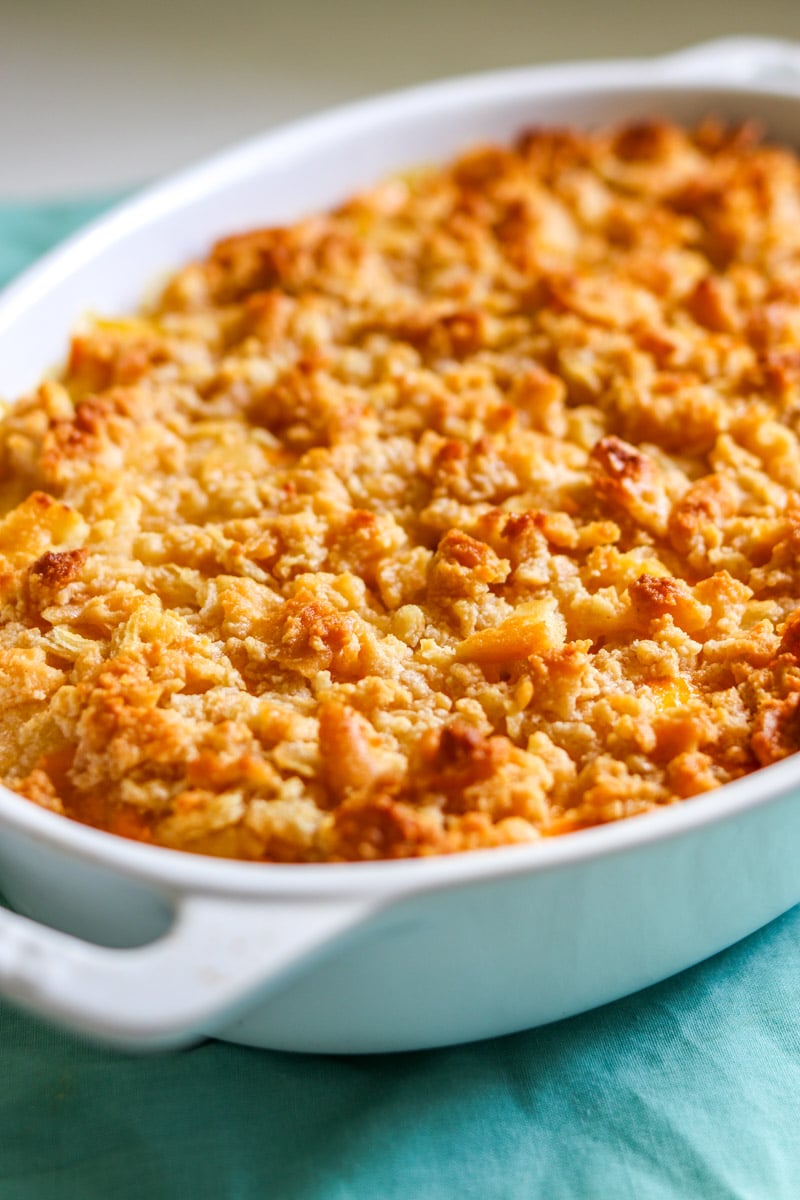 a fully baked pineapple cheese casserole in a white casserole dish. 