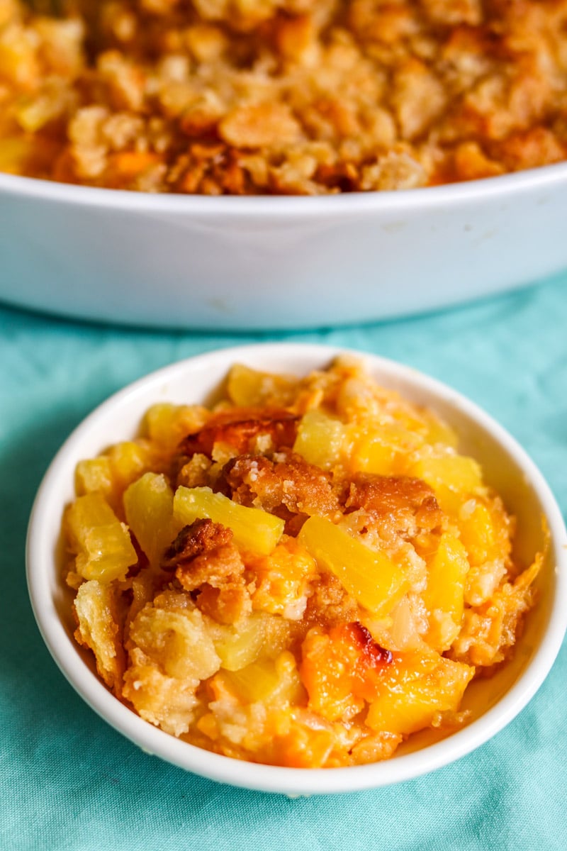 a close up of a bowl of pineapple cheese casserole. 