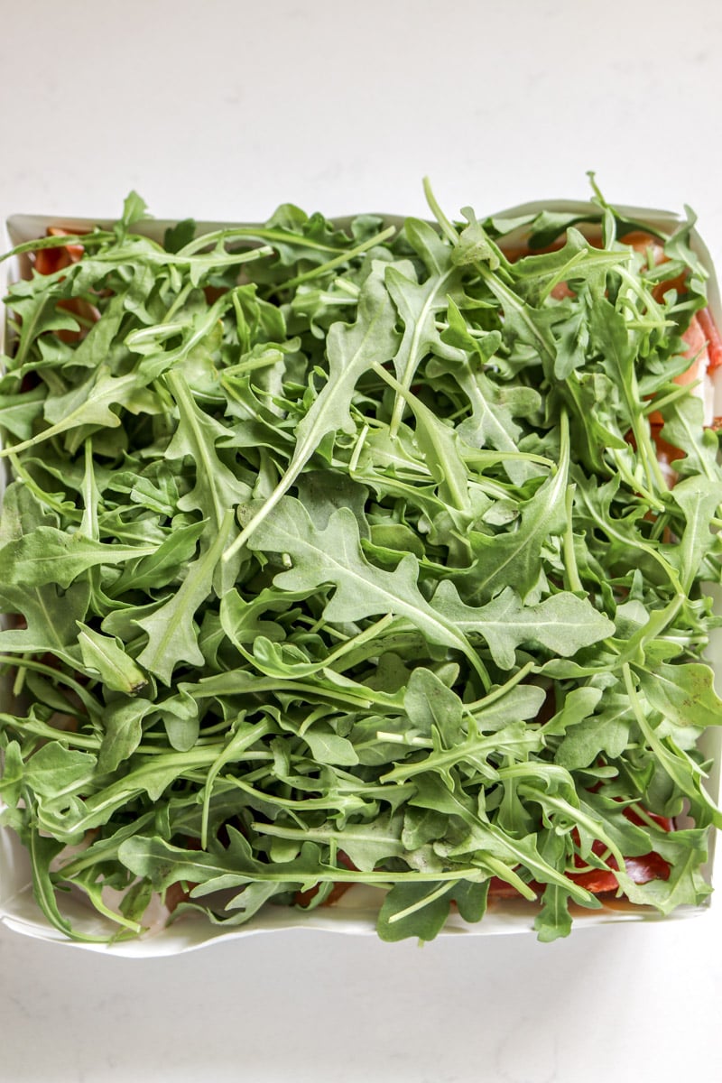 baby arugula on top of the sandwiches.