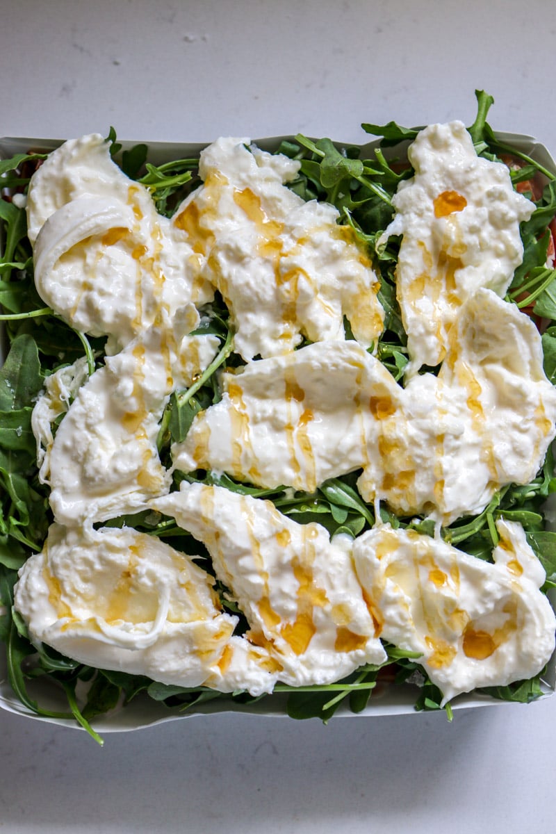 burrata with white balsamic glazed drizzled on top of sandwiches.