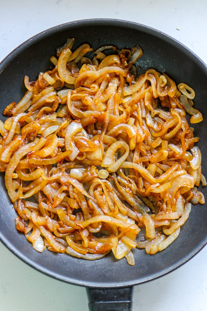 an overhead view of a pan full of quick caramelized onions.