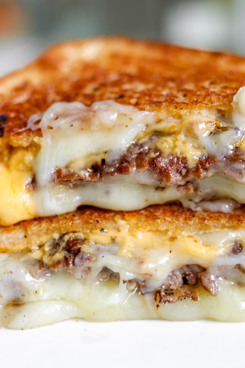 an up close vie of the layers of a smashburger grilled cheese.