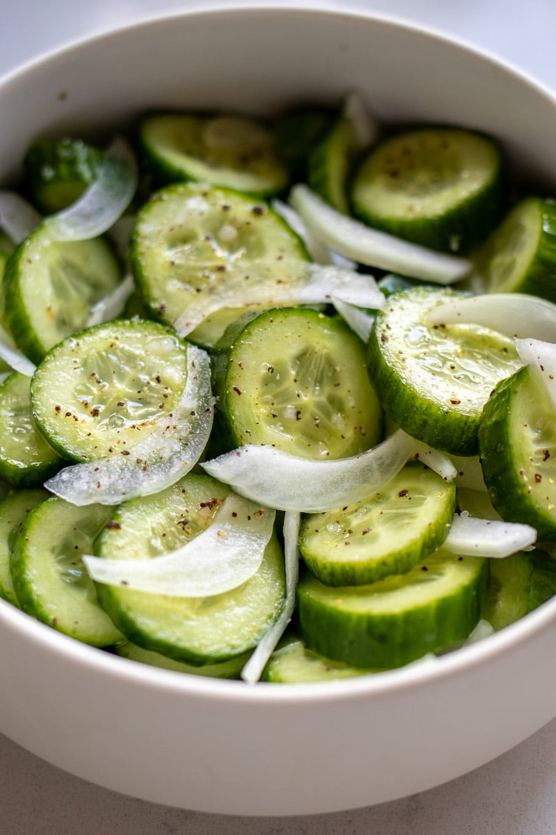 a white bowl filled with southern cucumber aslad. 