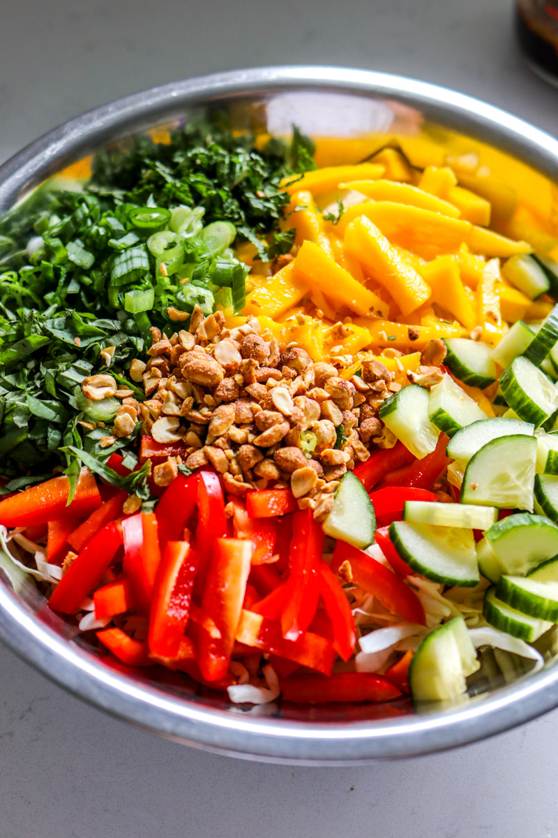 chopped colorful ingredients in a big silver mixing bowl.